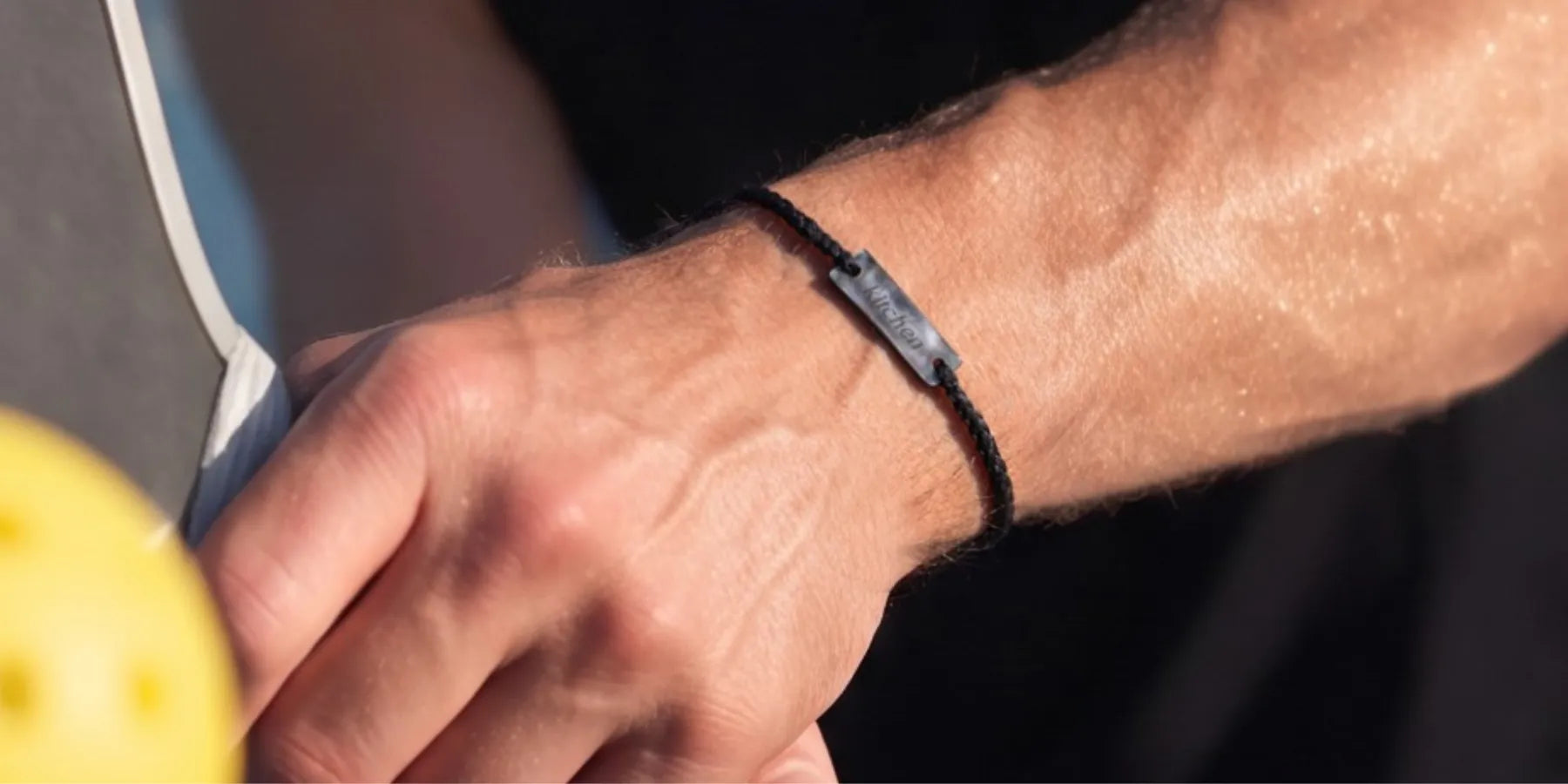 a man wearing a minimal pickleball bracelet