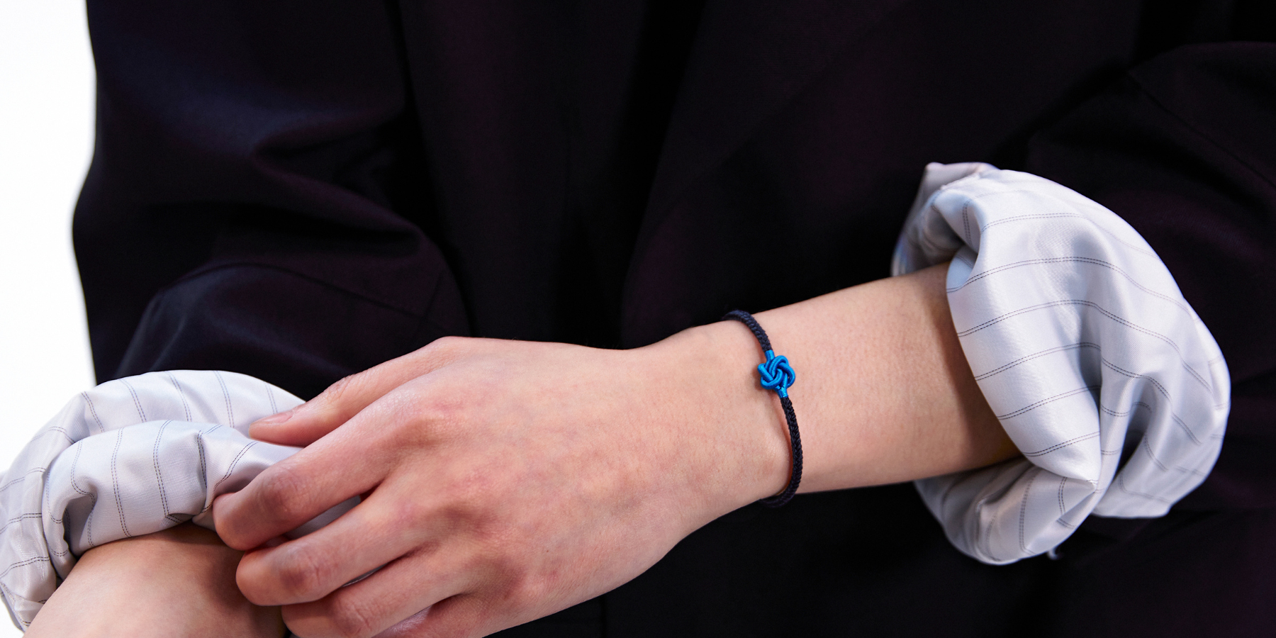 men wearing a black string bracelet
