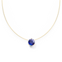 Gold nylon necklace with a blue sapphire on a white background