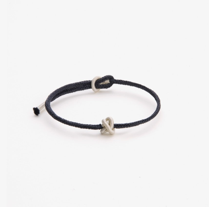 Black string bracelet with a white knot as gift for friends