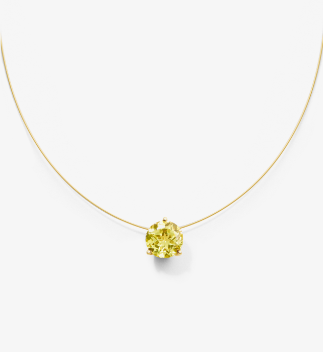 Gold nylon necklace with a yellow lab grown sapphire on a white background