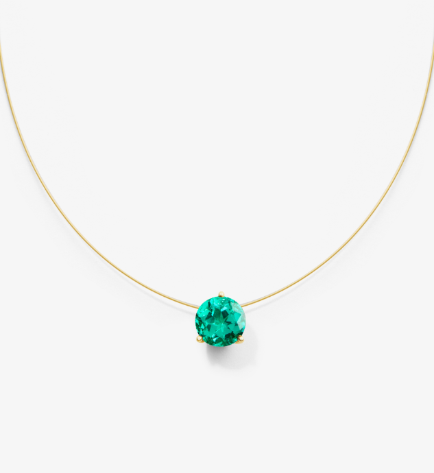 Gold nylon necklace with a green gemstone on a white background