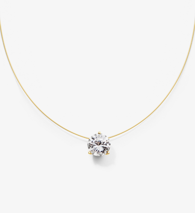 Gold nylon wire necklace with a clear gemstone pendant on a white background