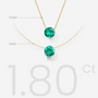 Gold nylon necklace with emerald stones labeled on a white background