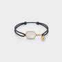 A string pickleball bracelet with a white paddle charm