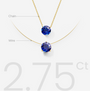 Gold nylon wire necklace with blue lab-grown sapphire labeled on a white background