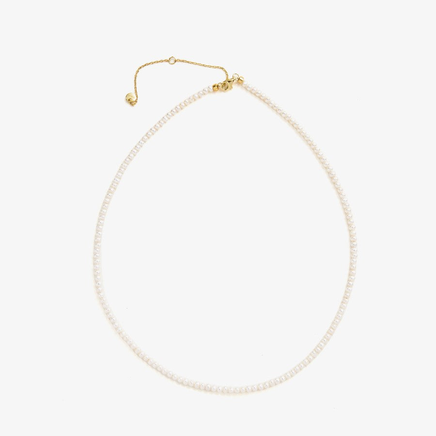 Pearl necklace with gold clasp on a white background
