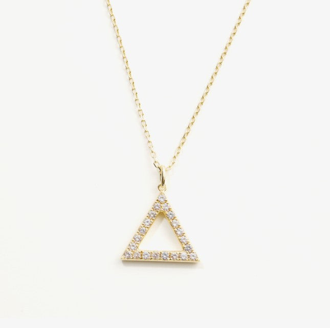 Gold triangle pendant necklace on a white background