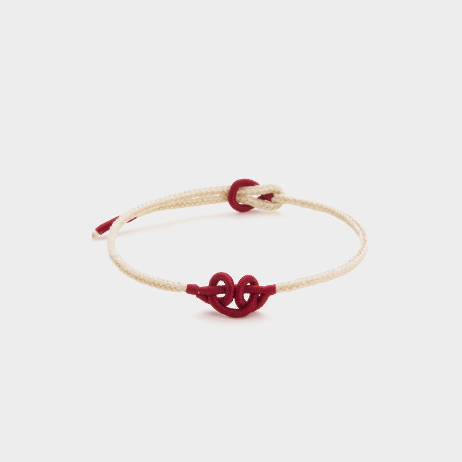 white string bracelet with a red wukong knot
