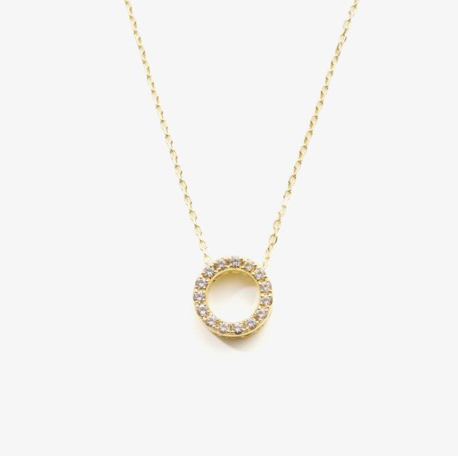 Gold necklace with a round pendant on a white background