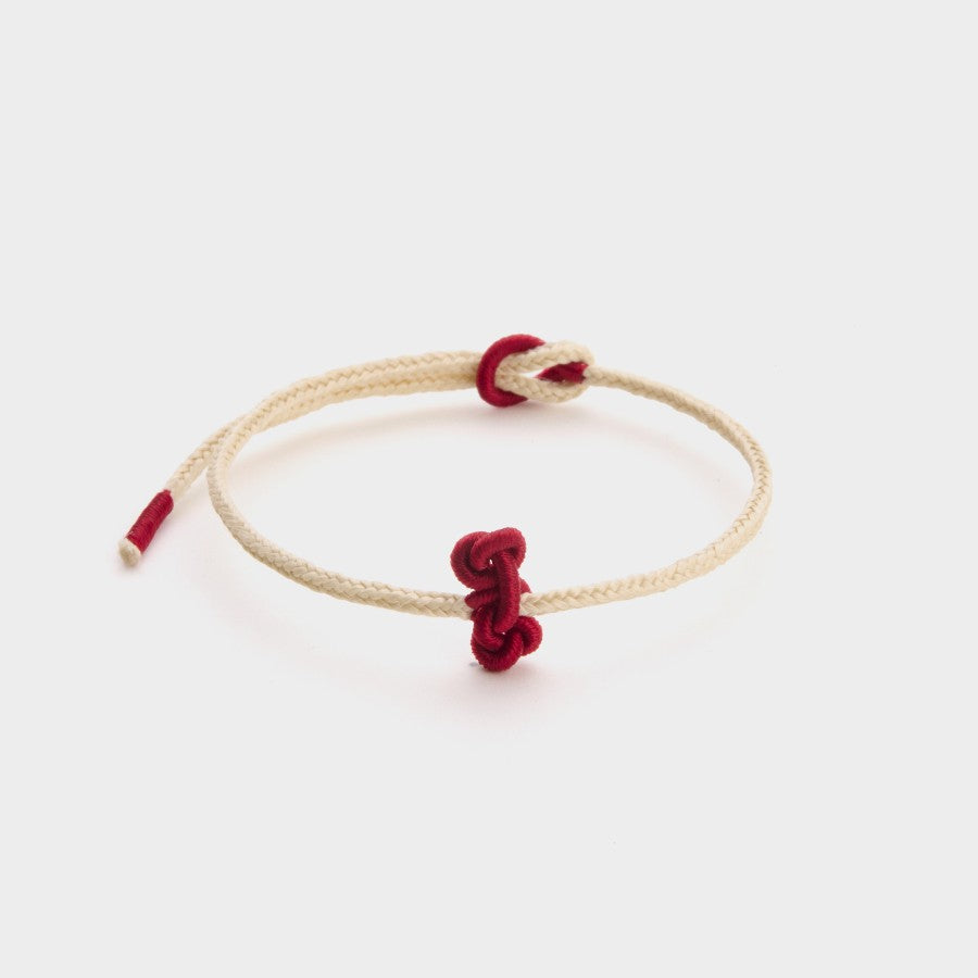 white string bracelet with a red wenchang knot