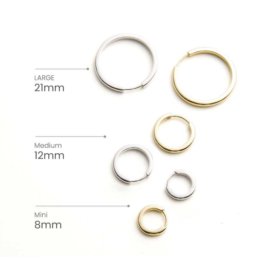 Set of gold and silver hoop earrings with size labels on a white background