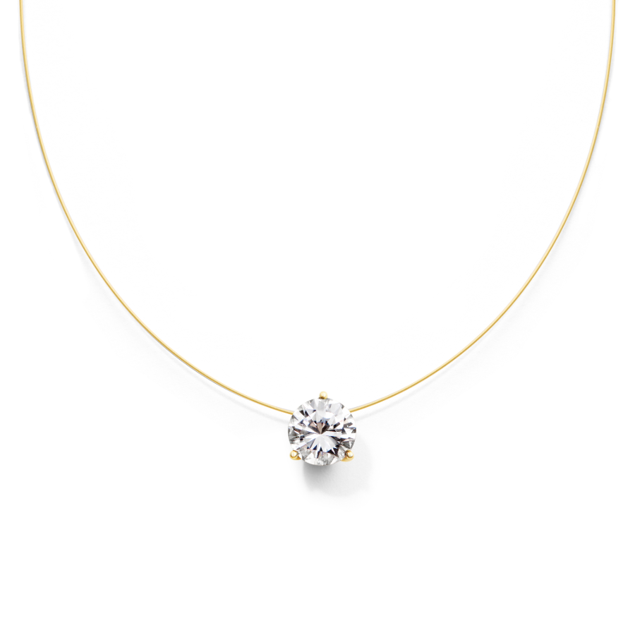 Gold wire necklace with a clear gemstone on a white background