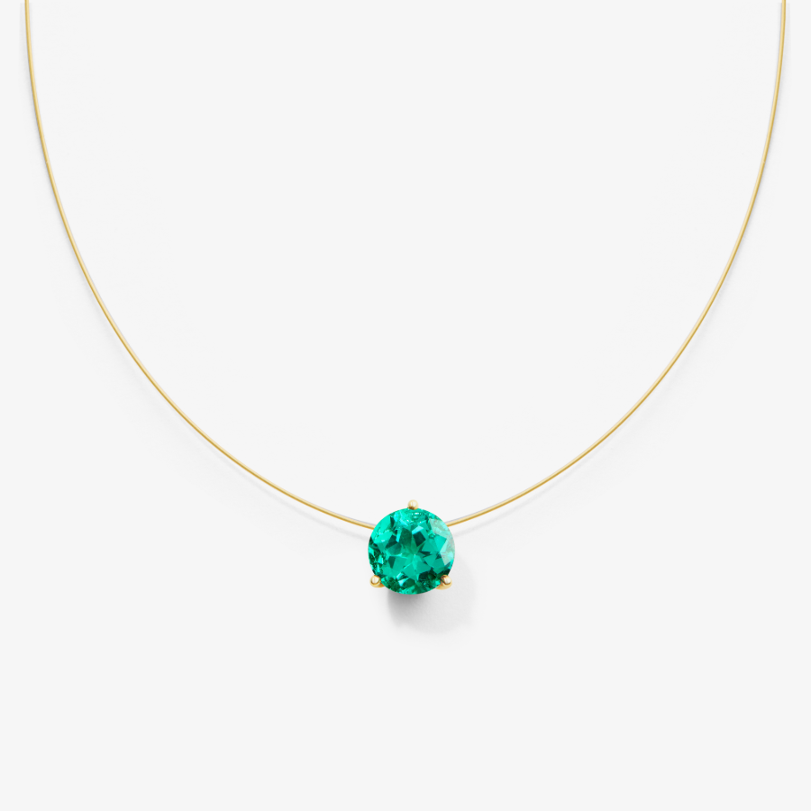 invisible nylon necklace with emerald pendant on a white background