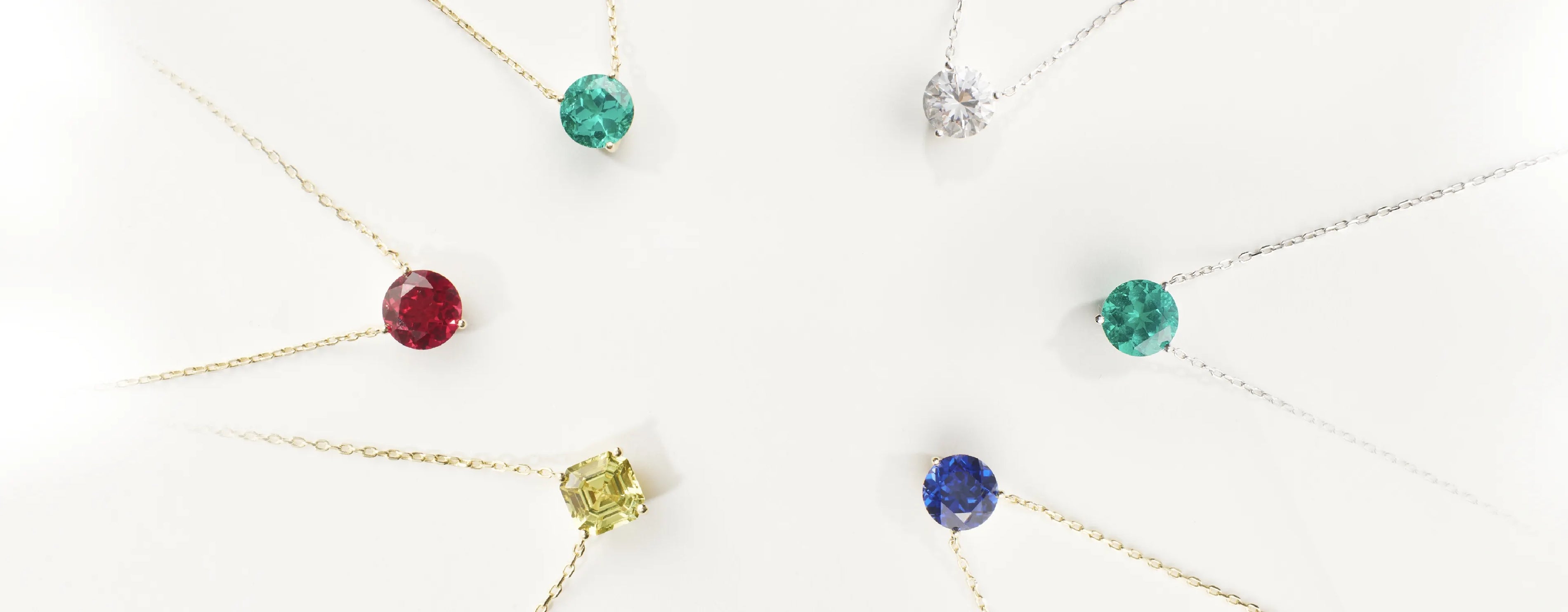 Set of gemstone necklaces on a white background