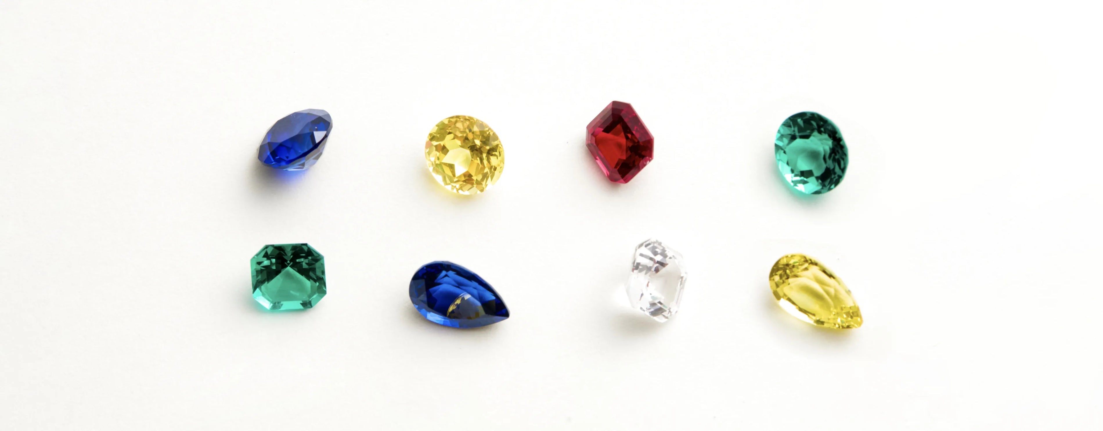 Collection of various colored gemstones on a white background